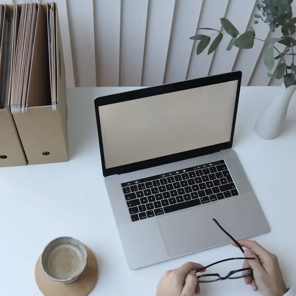 hands on desk holding glasses